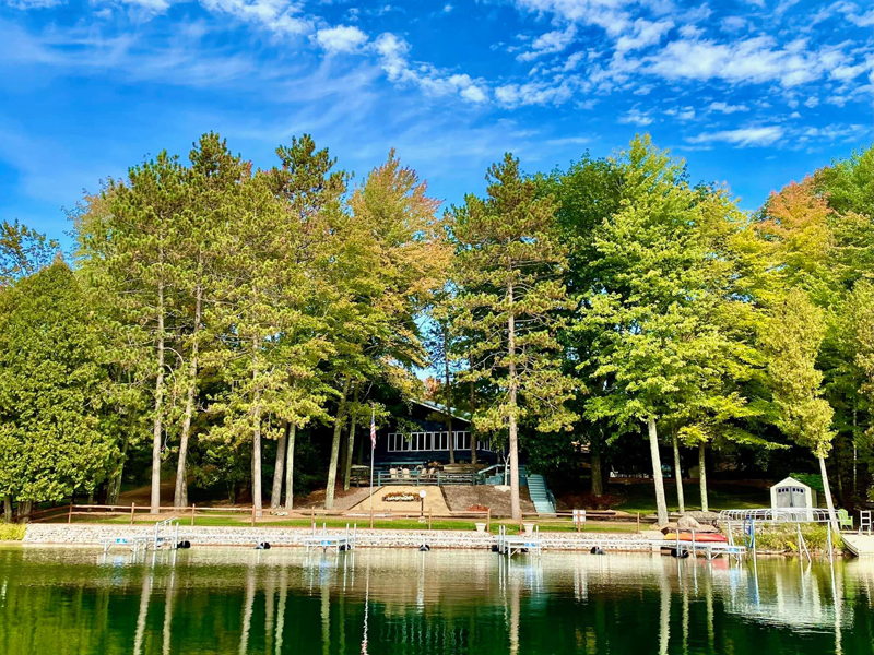 A beautiful shot of a country club from the lake with lush greenery