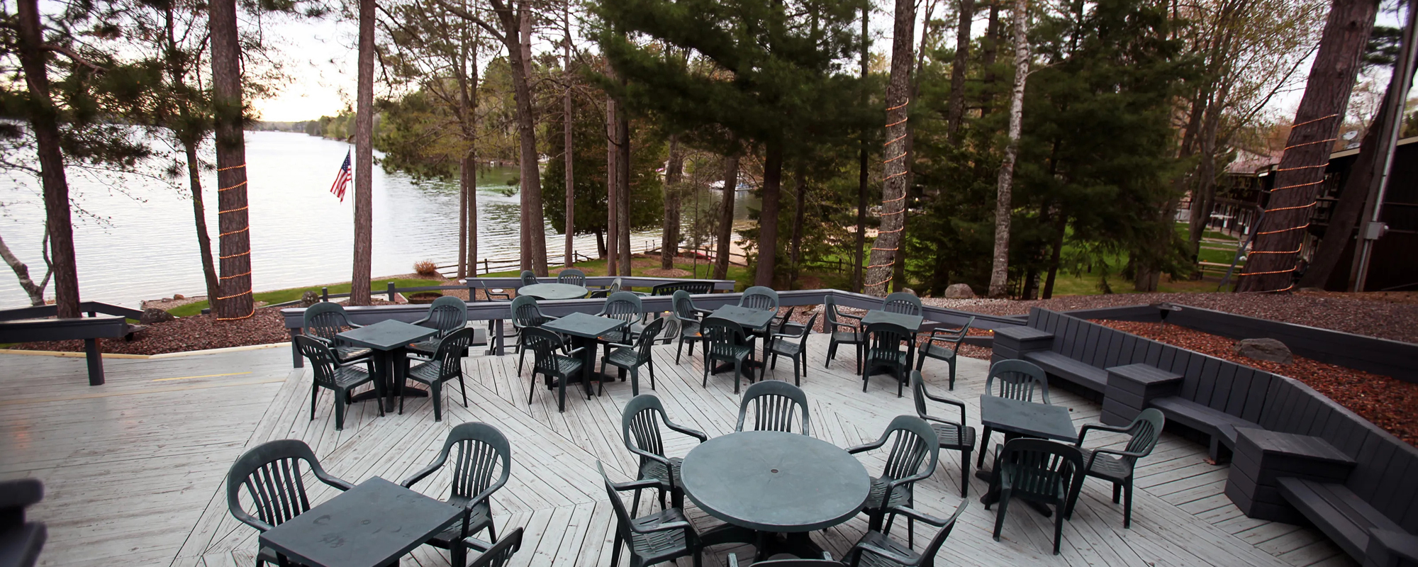 Patio seating on a beautiful deck overlooking a lake